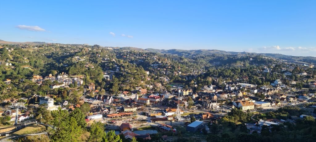 Vista do Parque Capivari em Campos do Jordão, com teleféricos e montanhas ao fundo.