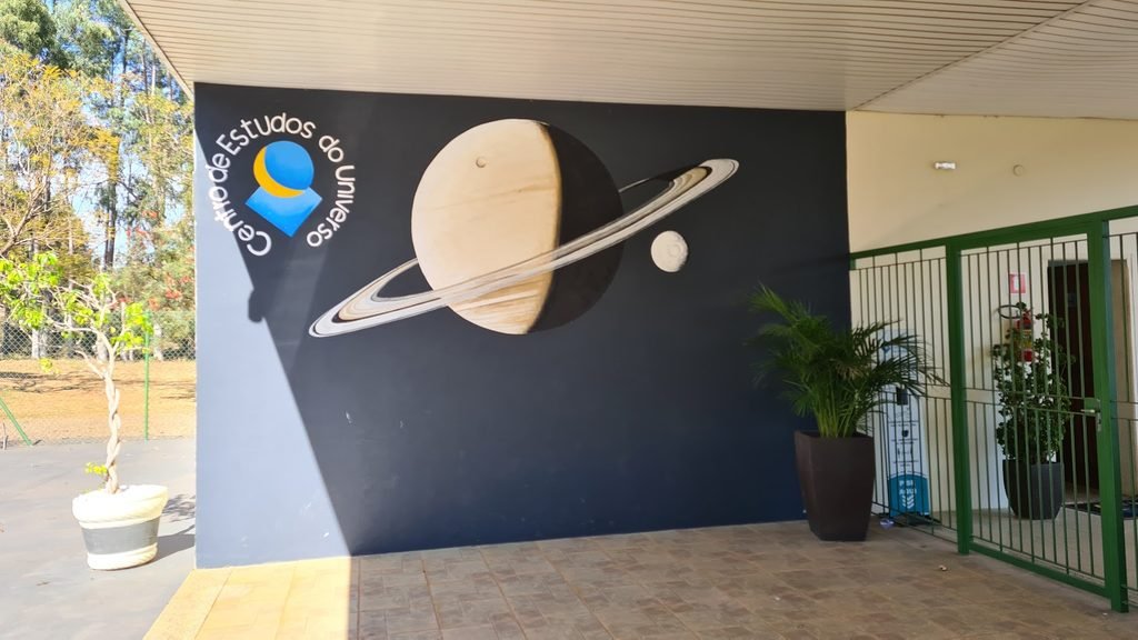Área do CEU no complexo do Brotas Eco Hotel Fazenda, com uma representação de Saturno suspensa na entrada.